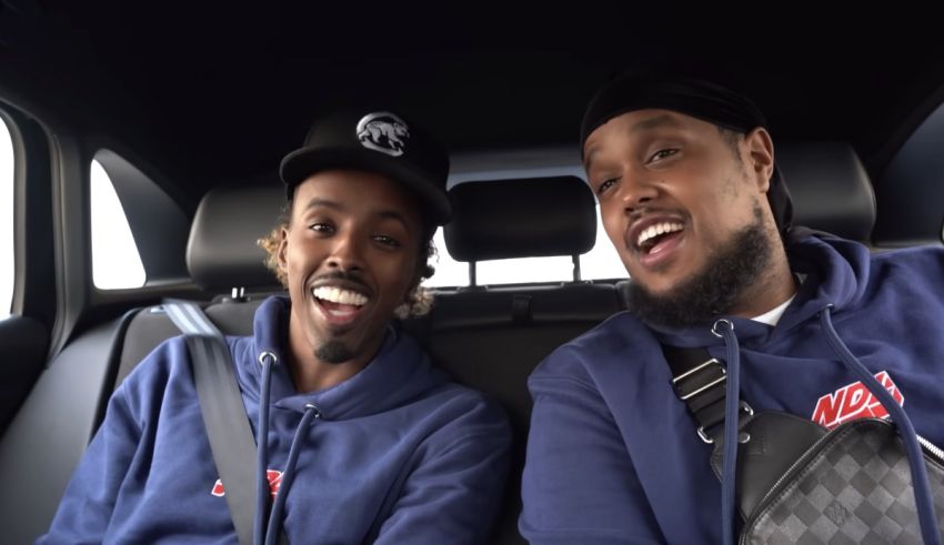 Two men sitting in the back seat of a car.