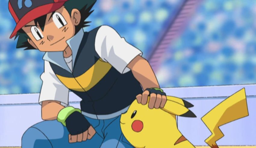 A boy is kneeling down next to a pokemon.