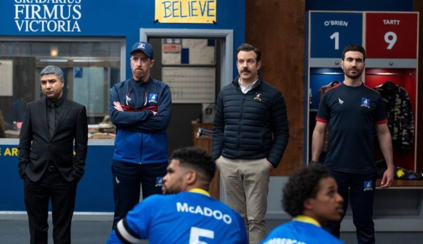 A group of men standing next to each other in a locker room.