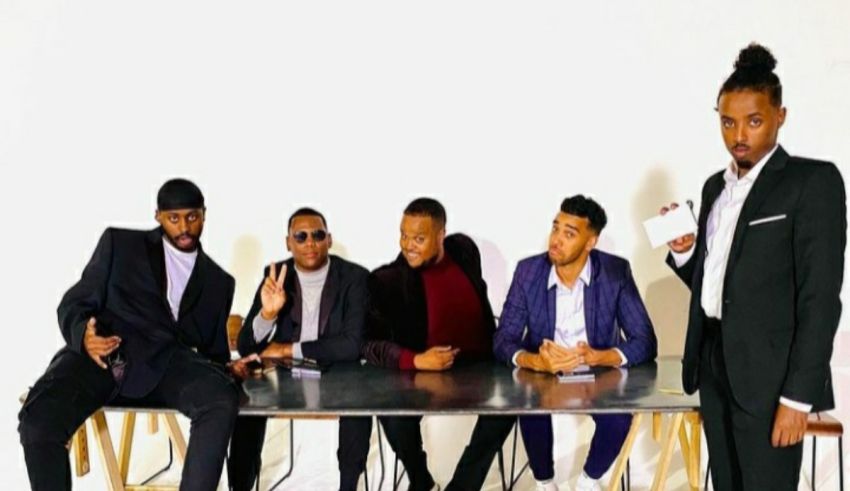 A group of men posing for a picture at a table.