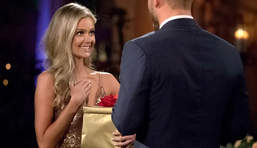 The bachelor contestant is holding a bouquet of roses.