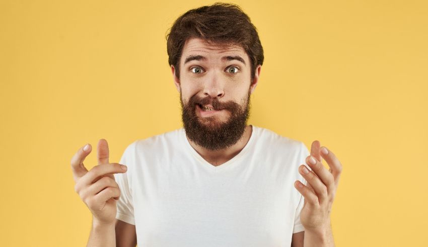 A man with a beard making a funny gesture.