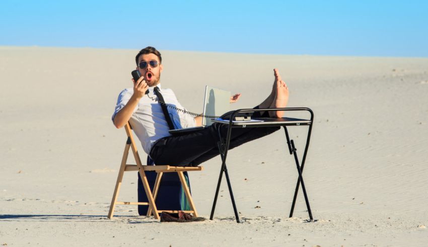 A man sitting on a chair in the desert.