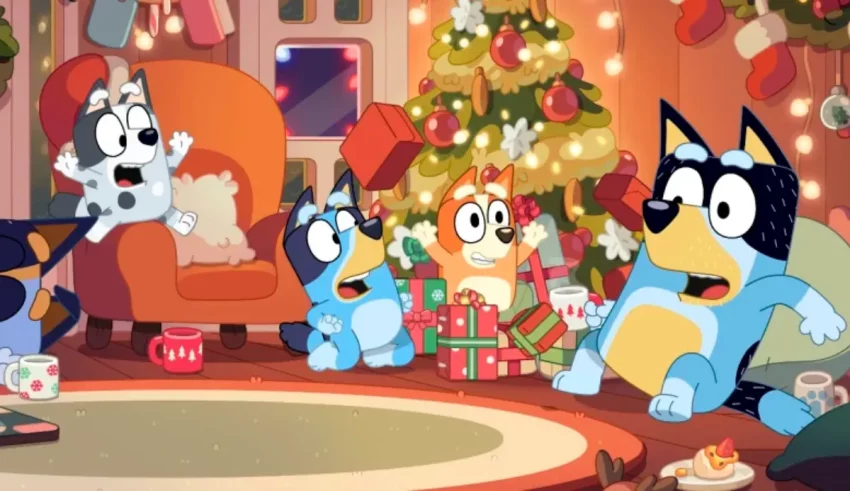 A group of cartoon animals in front of a christmas tree.