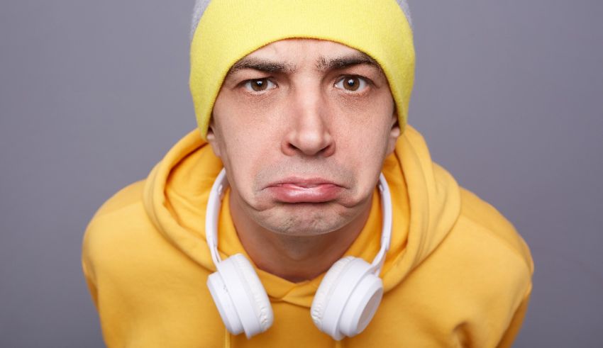 A man in a yellow beanie with headphones on his head.