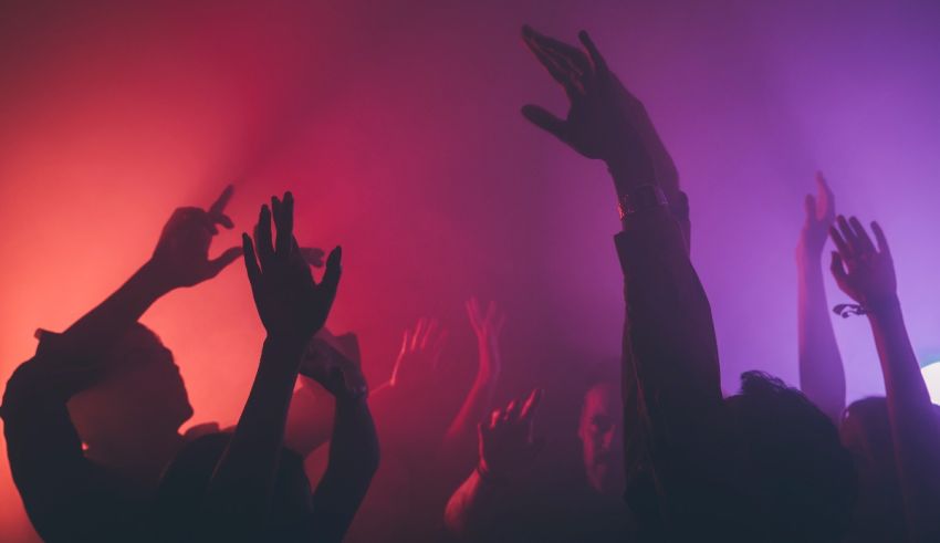 Silhouettes of people dancing at a nightclub.