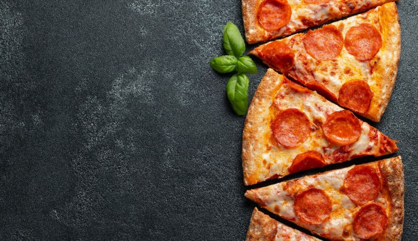 Pepperoni pizza slices on a black background.