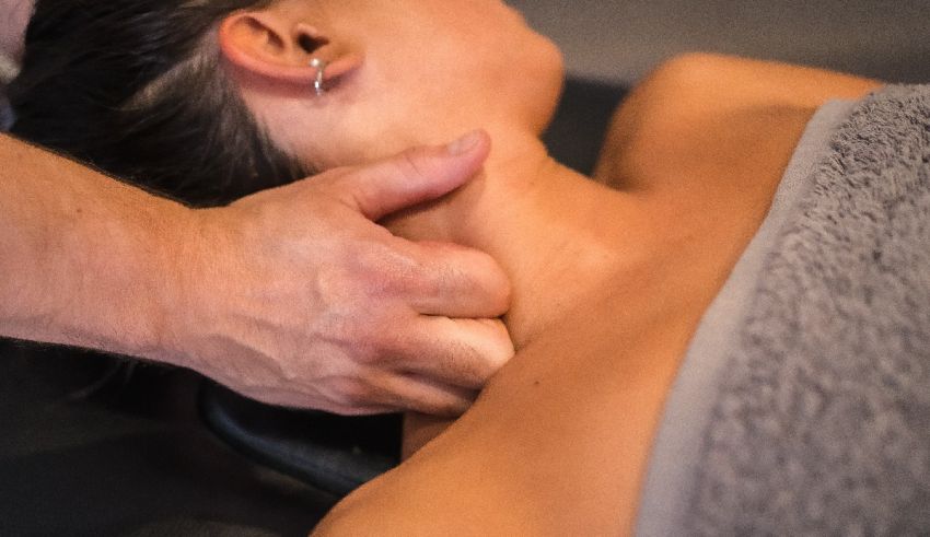 A woman getting a neck massage at a spa.