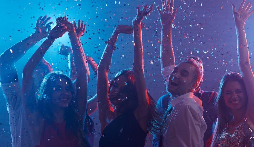 A group of people at a party with confetti in their hands.