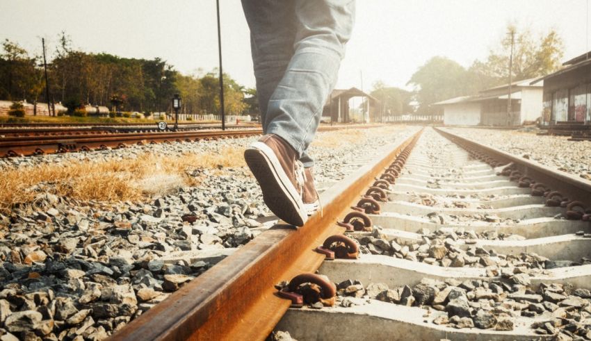 A person walking on a train track.