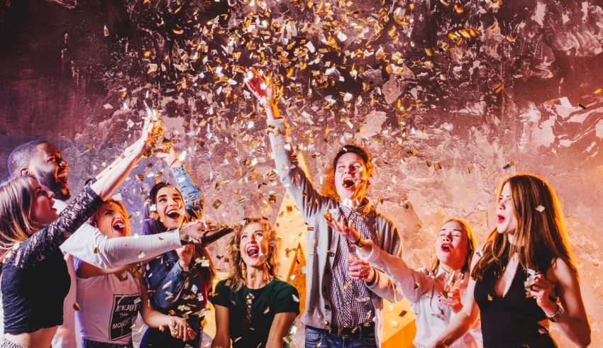 A group of people celebrating at a party with confetti.