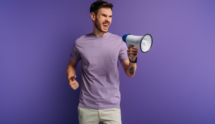 A man with a megaphone on a purple background.