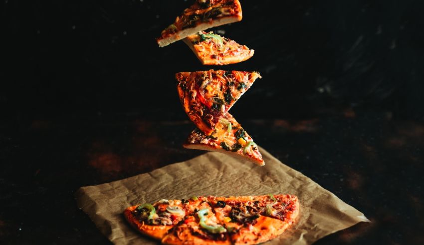 A slice of pizza flying in the air.