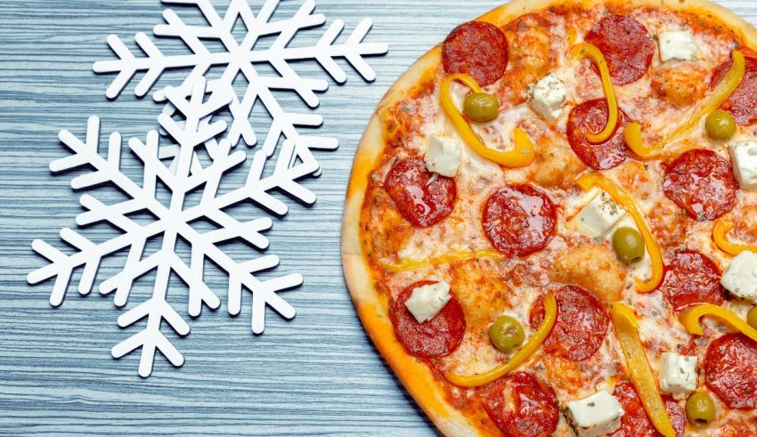 A pizza with pepperoni and peppers on top of a snowflake.