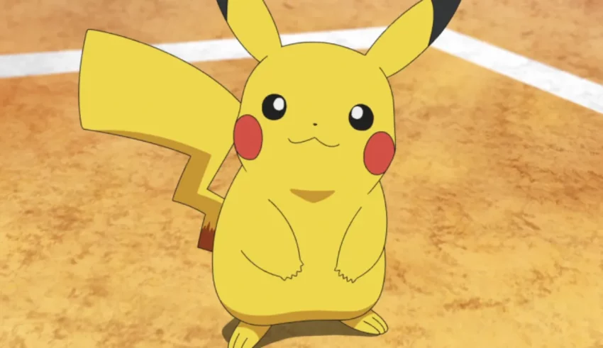 A pikachu is standing on a tennis court.