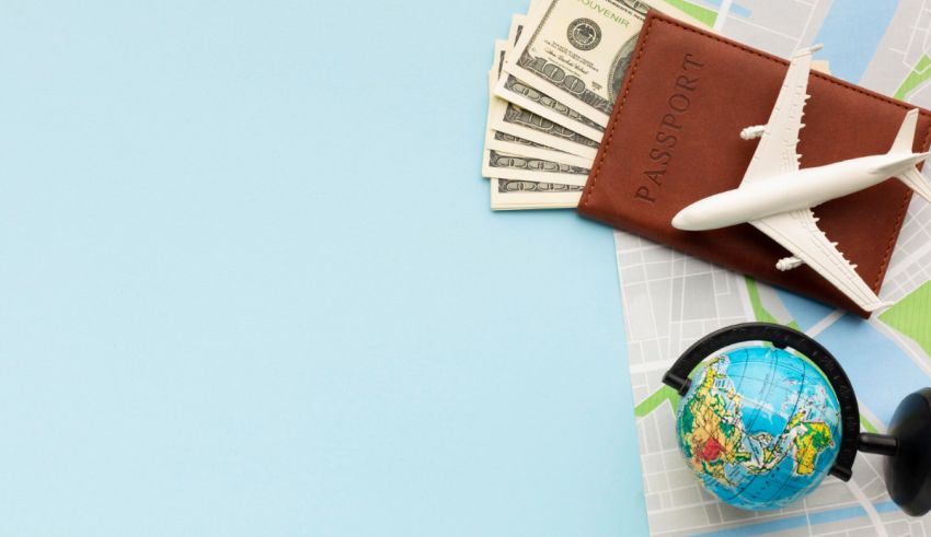 A pair of headphones, a wallet, and a globe on top of a map.