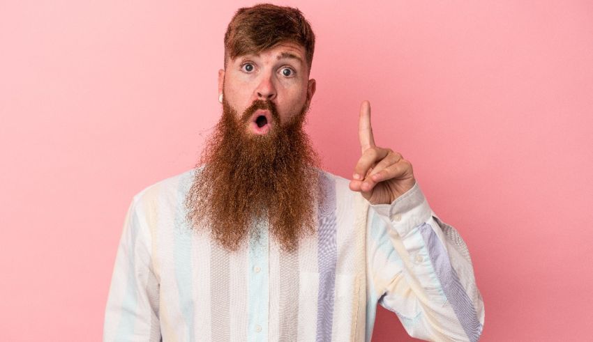 A man with a long beard is making a gesture with his finger.