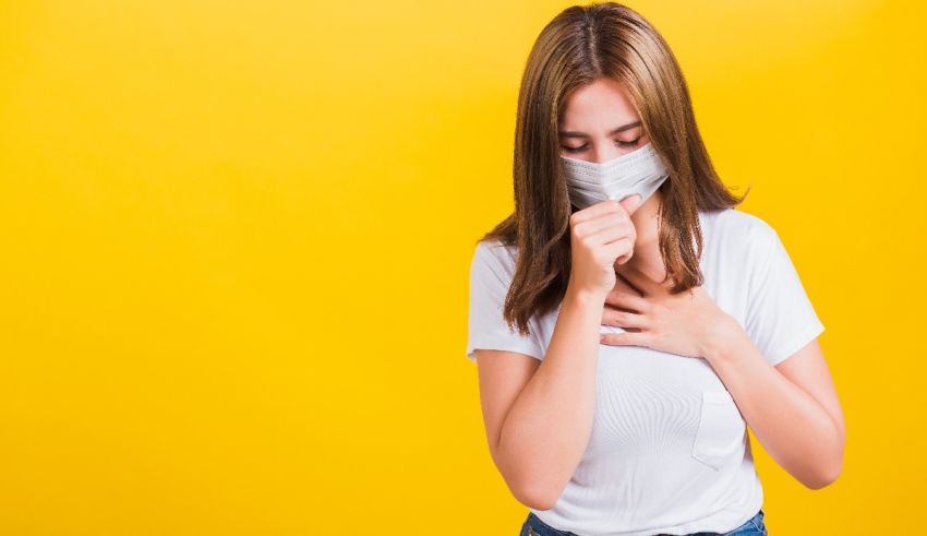 A woman wearing a surgical mask covering her chest.