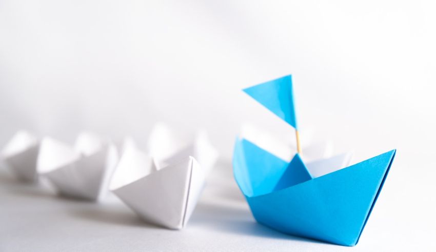 A group of blue and white paper boats on a white background.