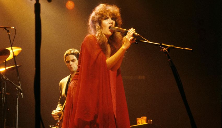 A woman in a red dress singing into a microphone.