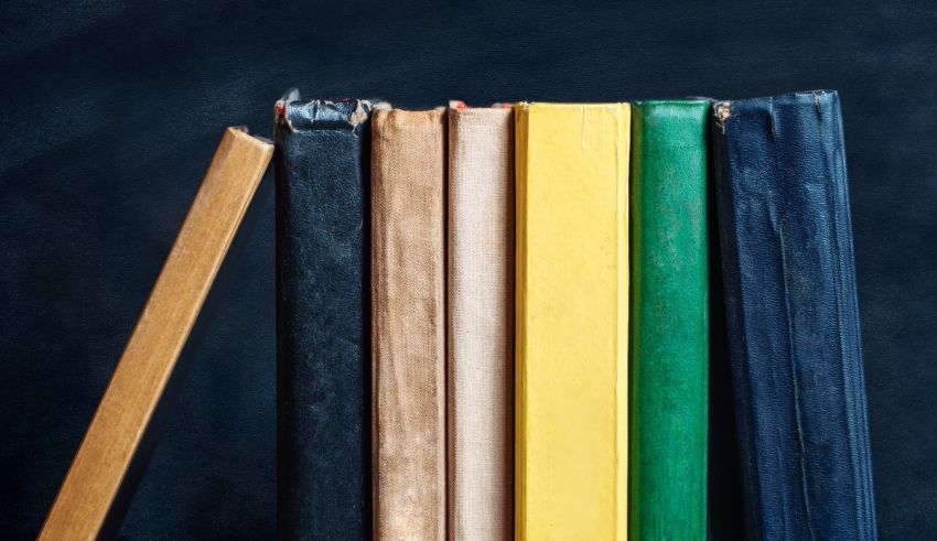A stack of colorful books on a black background.