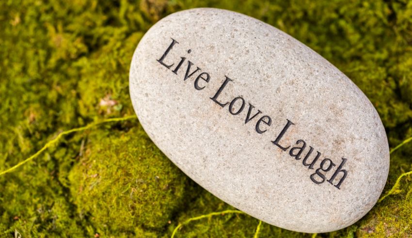 A stone with the word live love laugh on it.