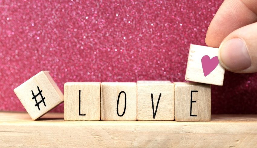A person holding wooden blocks with the word love on them.