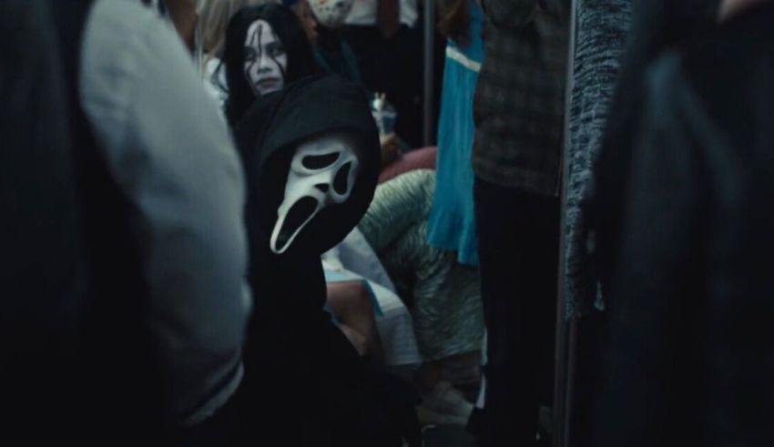 A group of people dressed in masks on a train.