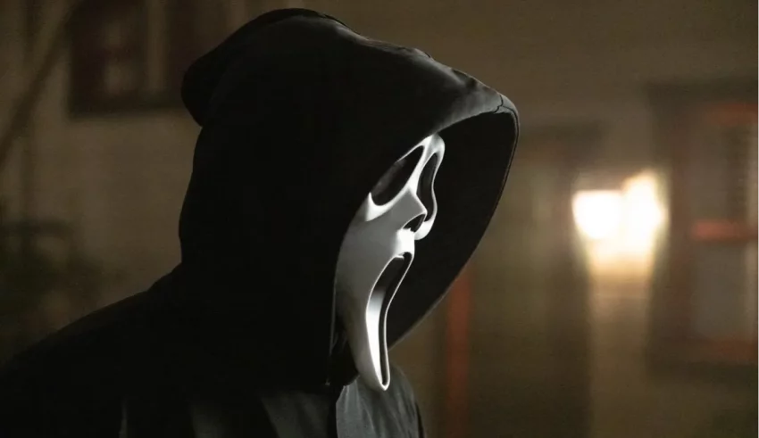 A man in a hoodie with a scream on his face.