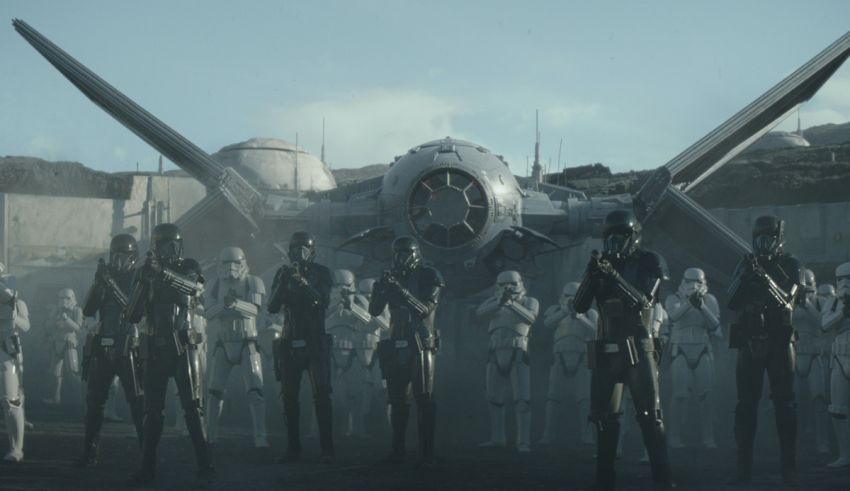A group of star wars troopers standing in front of an airplane.