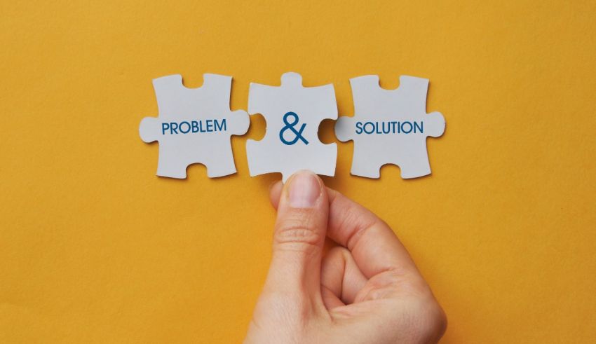A person holding a puzzle piece with the words problem and solution.