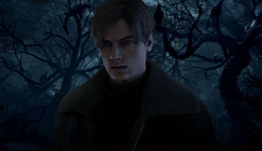 A man in a black jacket standing in a dark forest.
