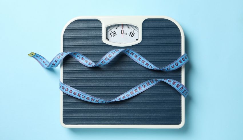 Weight scale with blue tape on blue background.