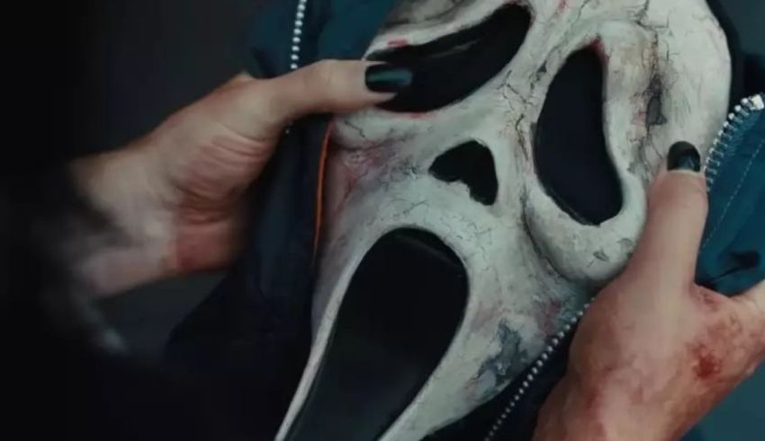 A person holding a scream mask.