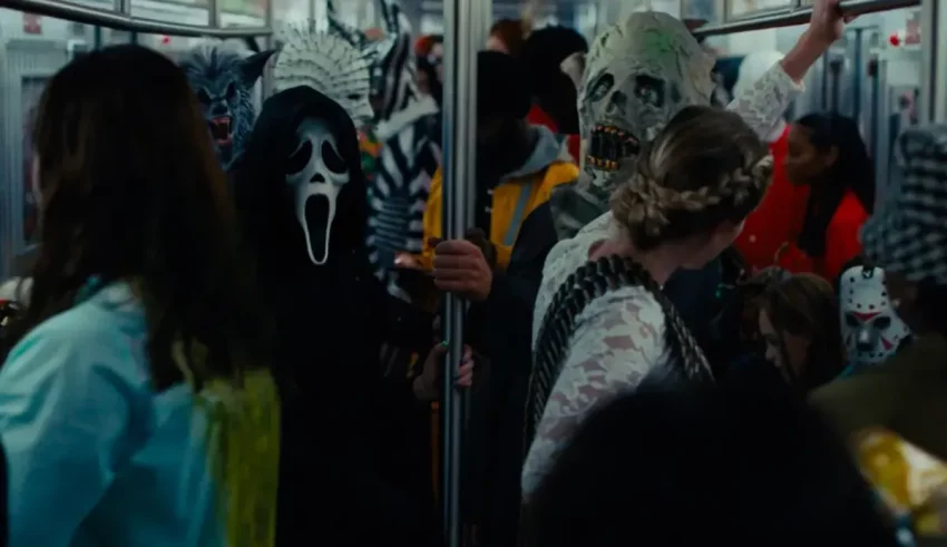 A group of people on a train with masks on.