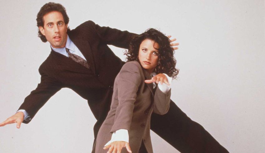 A man and woman posing in a business suit.