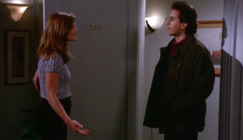 A man and woman standing next to each other in a hallway.