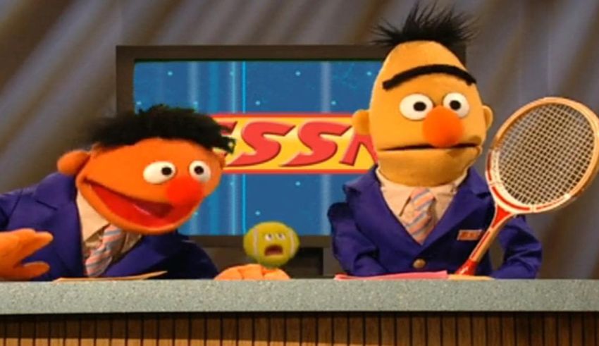 Two sesame street characters are holding tennis rackets.