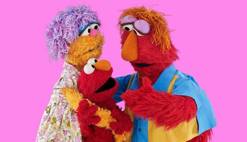Two sesame street characters are posing for a picture.
