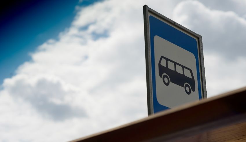 A blue and white sign with a bus on it.