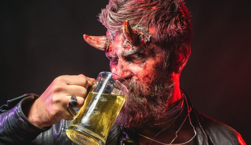 A devil drinking a beer with horns on his head.
