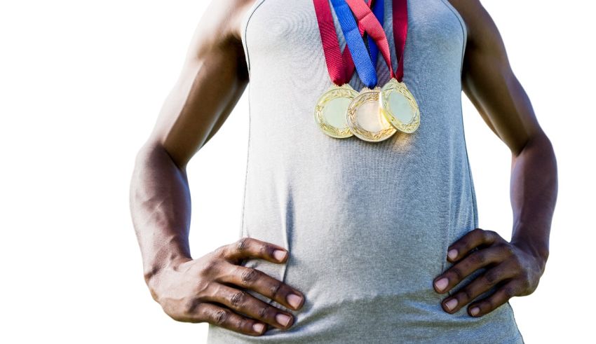 A man holding two medals in his hands.