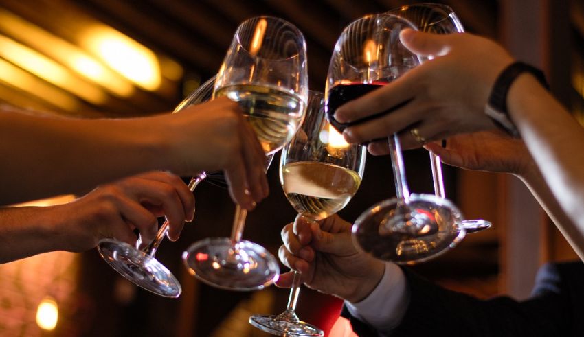 A group of people toasting wine glasses.