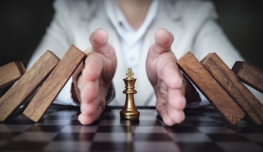 Businesswoman holding a chess piece on a chess board.