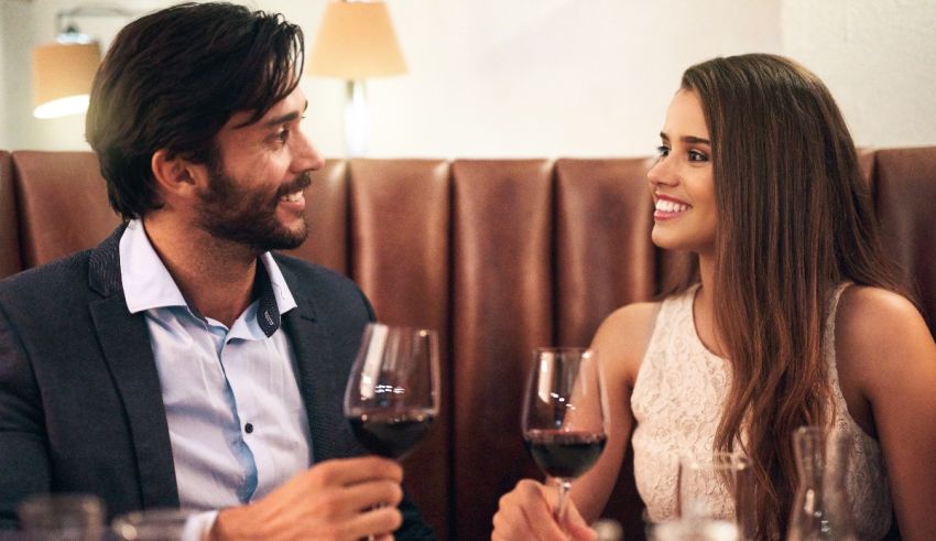 A man and woman drinking wine in a restaurant.