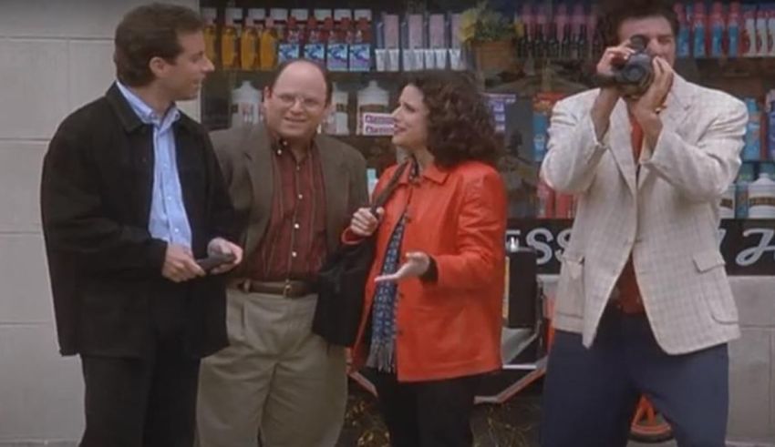 A group of people standing in front of a store.