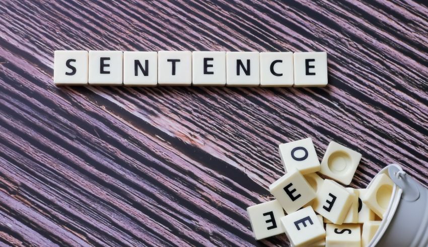 The word sentence spelled out on a wooden table.