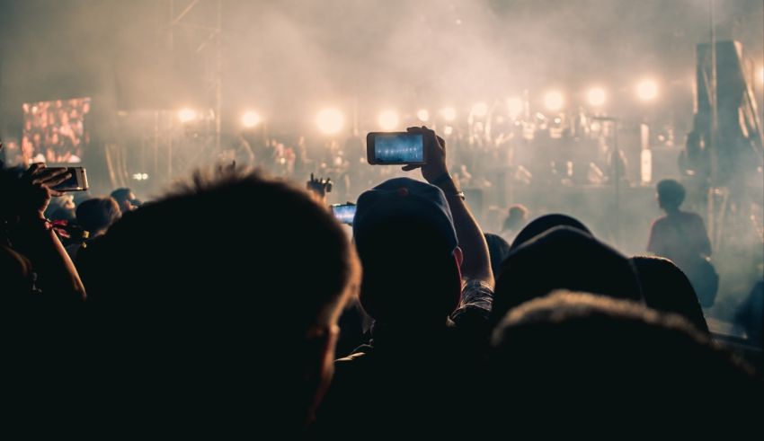 A crowd of people taking pictures at a concert.