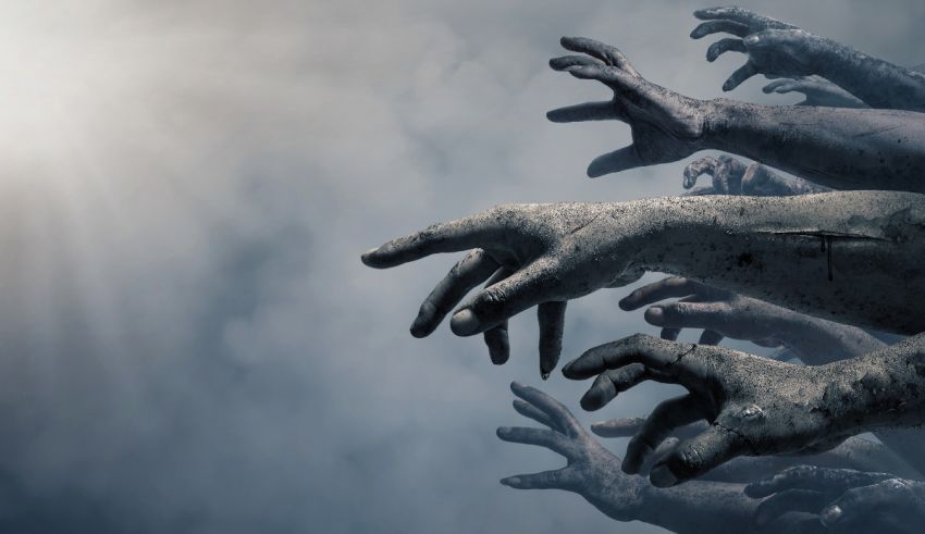 A group of zombie hands reaching out to the sky.