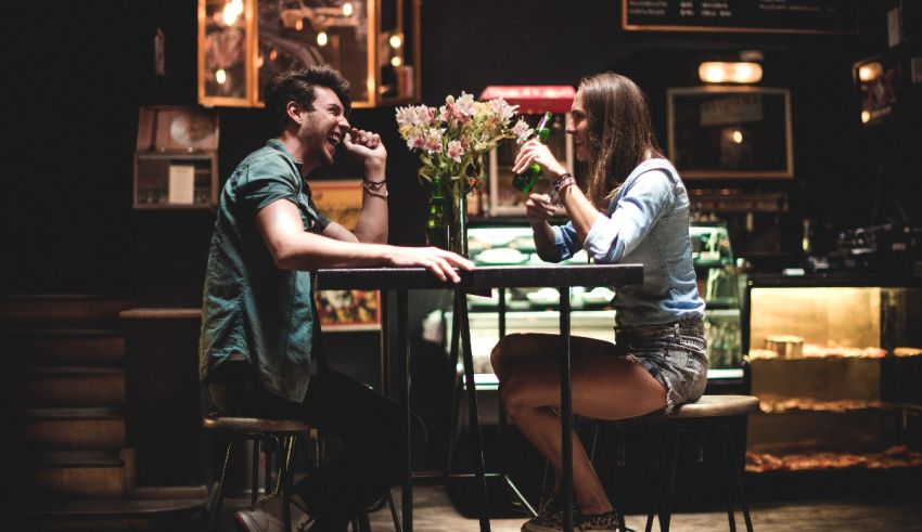 A man and woman sitting at a table in a coffee shop.